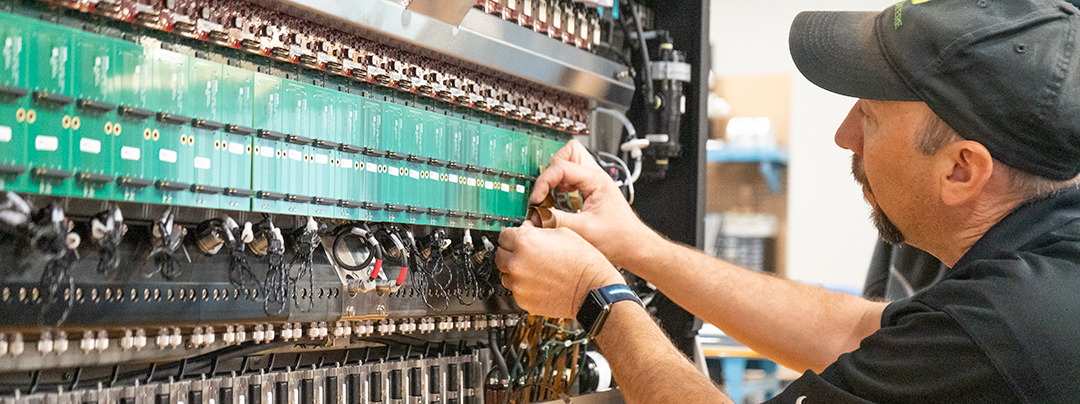 Worker installing printheads in large printbar